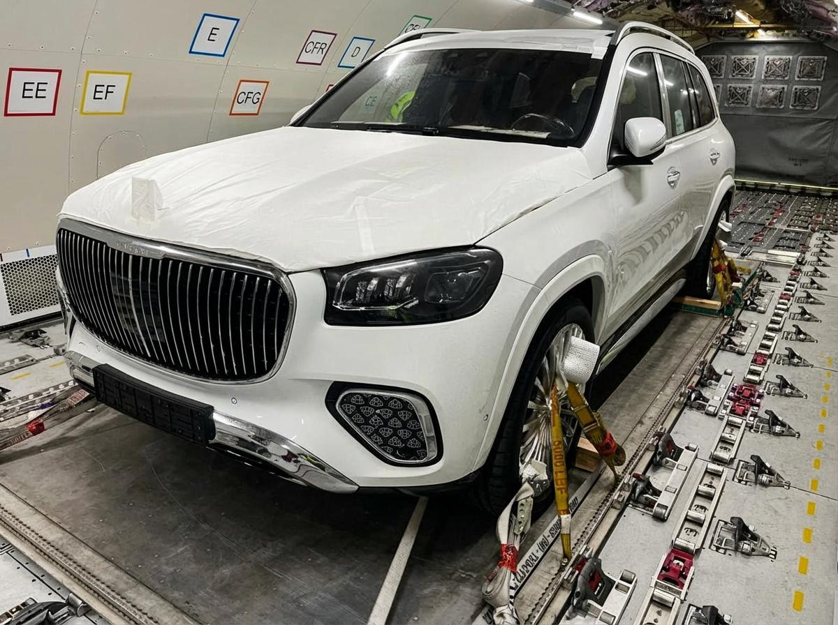 Luxury car secured inside aircraft cargo hold - AirBuzz International air freight